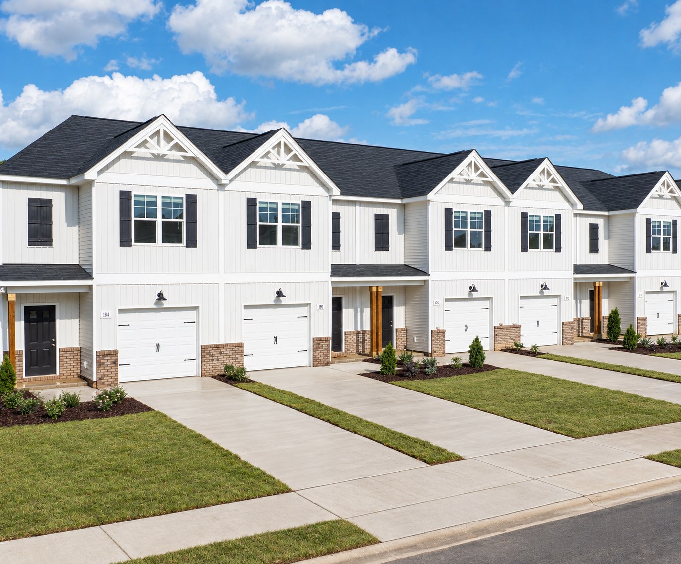 New white Marin Woods townhomes with garages and landscaped lawns