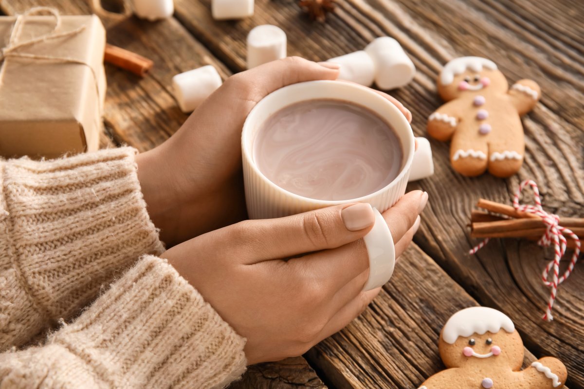 person holding hot cocoa cup