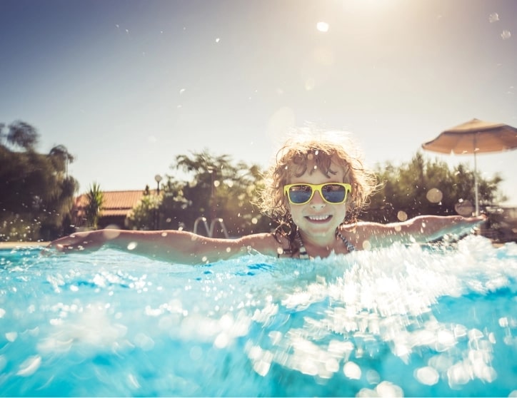 A child swimming in an outdoor pool